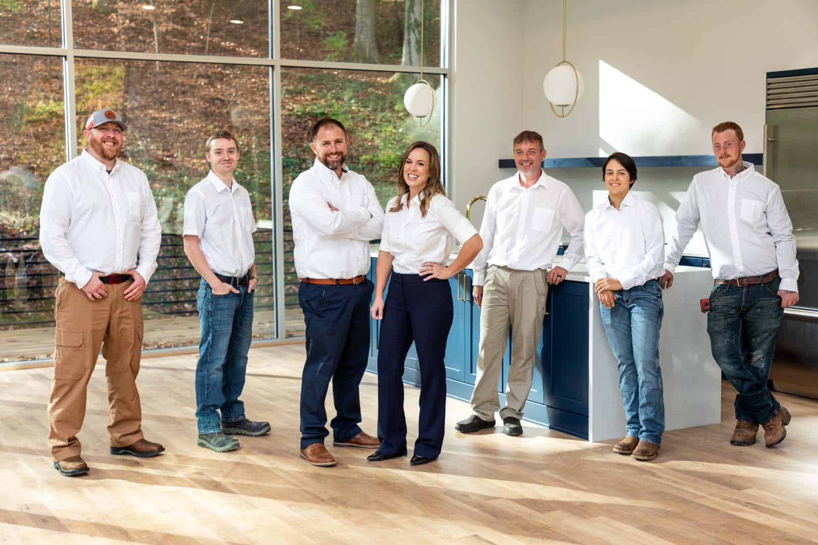 A photo of the Bio Plumbing team. Seven plumbers in white button ups.
